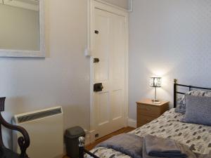 a bedroom with a bed and a white door at Cuillin View Apartment - Uk12529 in Arisaig +21 photos