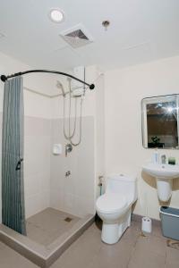 a bathroom with a shower and a toilet and a sink at NEW Elegant 1BR Condo Cebu IT Park Hotspot in Cebu City