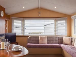 a living room with a couch and a table at Stay And Sea in Heysham