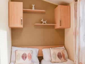 a small room with two pillows on a couch at Stay And Sea in Heysham +4 photos