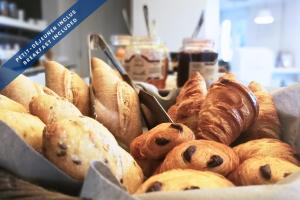 a bunch of different types of pastries in a basket at Hôtel Les Voiles in Toulon