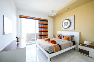 a bedroom with a bed and a large window at Apartment with Private Jacuzzi and Terrace in St Julians 3 Bedrooms in St. Julianʼs