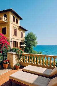 a house with a balcony with a view of the ocean at Villa Lina in Castiglioncello