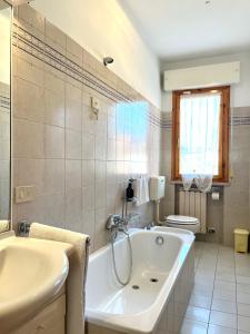 Un baño con bañera, lavabo e inodoro. en La Casa Del Mare, en Torre del Lago Puccini