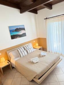 a bedroom with a bed with two towels on it at Villa Blue Horizon- Costa Paradiso in Costa Paradiso