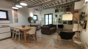 Una cocina y una sala de estar con mesa y sillas. en Porta Fiorentina Home, en Castiglion Fiorentino