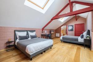 a bedroom with two beds in a attic at Marc's Flat - Calm & Cosy in Nantes +25 photos