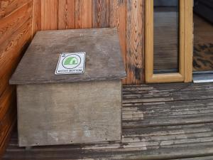 a wooden step with a sign on it next to a door at Withy Bottom-Uk1393 in Corney