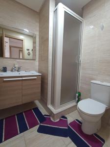 a bathroom with a toilet and a shower and a sink at Appartement à Prestigia Plage des nations salé in Sale