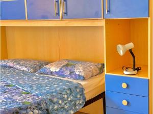 a bedroom with a bed and a lamp and cabinets at Florentine Castle Apartment in Castelfiorentino +2 photos