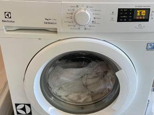 a washing machine with a digital clock on it at Florentine Castle Apartment in Castelfiorentino