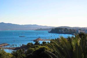 a beach with a bunch of boats in the water at Hôtel Les Voiles in Toulon