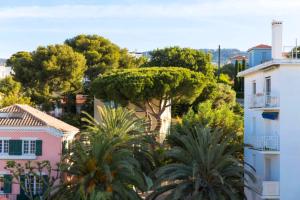 a view of a city with trees and buildings at Hôtel Les Voiles in Toulon