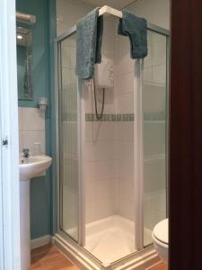 a shower with a glass door in a bathroom at Springfield Hotel in Blackpool