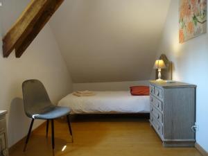 a bedroom with a bed and a desk and a chair at Relais Solognot in Sennely