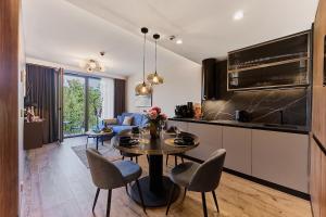 a kitchen and living room with a table and chairs at Golden Hour Apartments- Loft H 214 in Świnoujście