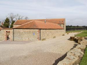 a large brick building with a red roof at The Loft - 26477 in North Willingham