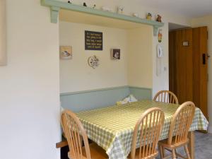 a dining room with a table and chairs and a table and a table and chairs at The Cottage in Sinnington