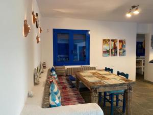 a living room with a wooden table and a couch at Villa marina in Ermioni