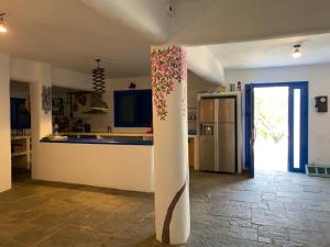 a kitchen with a column in the middle of a room at Villa marina in Ermioni