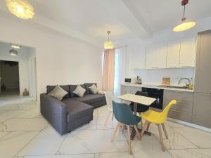 a living room with a couch and a table and chairs at Hotel Cazino Nord in Mamaia