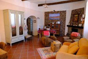 a living room filled with furniture and a fireplace at La sosta del Viandante in Borgomaro
