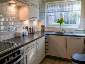 a kitchen with a sink and a counter top at Arthur's Place in Reighton