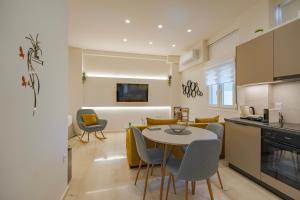 a kitchen and living room with a table and chairs at Ephantasy Living - Premium City Apartments in Heraklio