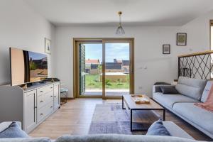 a living room with a couch and a tv at Villa Franka - holiday home with a private pool in Sveti Filip i Jakov