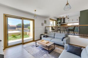 a living room with a couch and a table at Villa Franka - holiday home with a private pool in Sveti Filip i Jakov