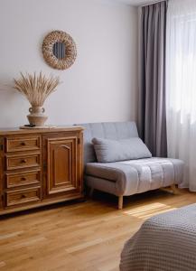 a living room with a couch and a dresser at Freda Self Check-in in Nida +39 photos