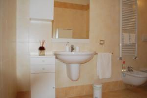 a bathroom with a white sink and a toilet at Lovely Apartment Verona in Verona