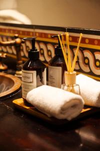 a bathroom counter with two bottles of soap and towels at Hotel Boutique Patio Corao in Cartagena de Indias