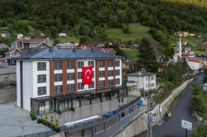 a building with a canadian flag on top of it at Demederon Hotel in Hamsikoy