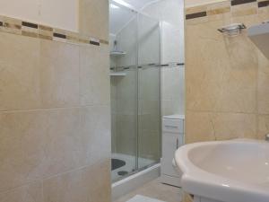 a bathroom with a shower and a toilet and a sink at Cobb's Cottage in Grosmont +4 photos