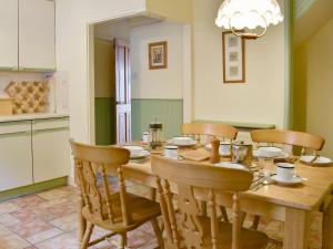 een eetkamer met een houten tafel en stoelen bij Thurston View in Coniston