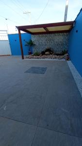 a concrete patio with awning on the side of a building at Horizonte Azul in Cabo Frio
