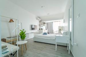 a white bedroom with a bed and a desk at Lalic Gallery Villa in Bibinje +48 photos