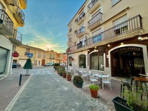 a street with chairs and tables and a building at Vacation Apartment in Els Poblets