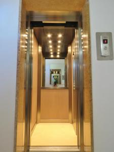 a hallway with a mirror in a building at Hotel Adriatico in Bibione