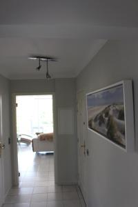 a room with a hallway with a painting on the wall at Aan zee in Nieuwpoort in Nieuwpoort