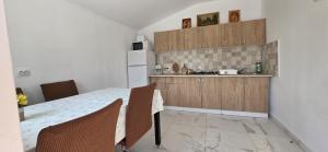 a kitchen with a table and chairs in a room at Casa Gimi in Baile Unu Mai
