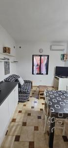 a kitchen and living room with a table and chairs at Casa Rosanna in Porto Ottiolu