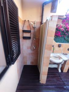 a bathroom with a shower with a toilet and a sink at Casa Rosanna in Porto Ottiolu