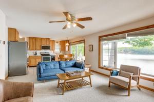 a living room with a blue couch and a kitchen at Dock and Views Scenic Lakefront Escape in Harrison in Harrison