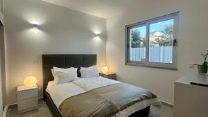 a bedroom with a large bed with two lamps at Villa Belinha B by Check-in Portugal in Quarteira +21 photos