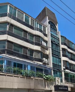 an apartment building with a car on a balcony at The Bom Stay in Daegu