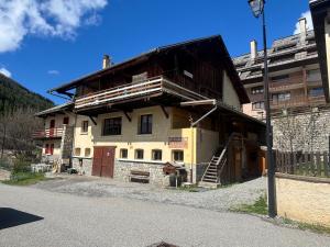 a large building with a balcony on the side of it at Le Villard appartement Adrech in Abriès
