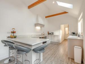 a kitchen with a white counter and stools at High Garden in Belton