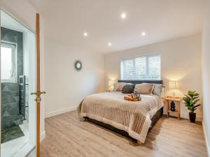 a bedroom with a large bed and a shower at High Garden in Belton +7 photos